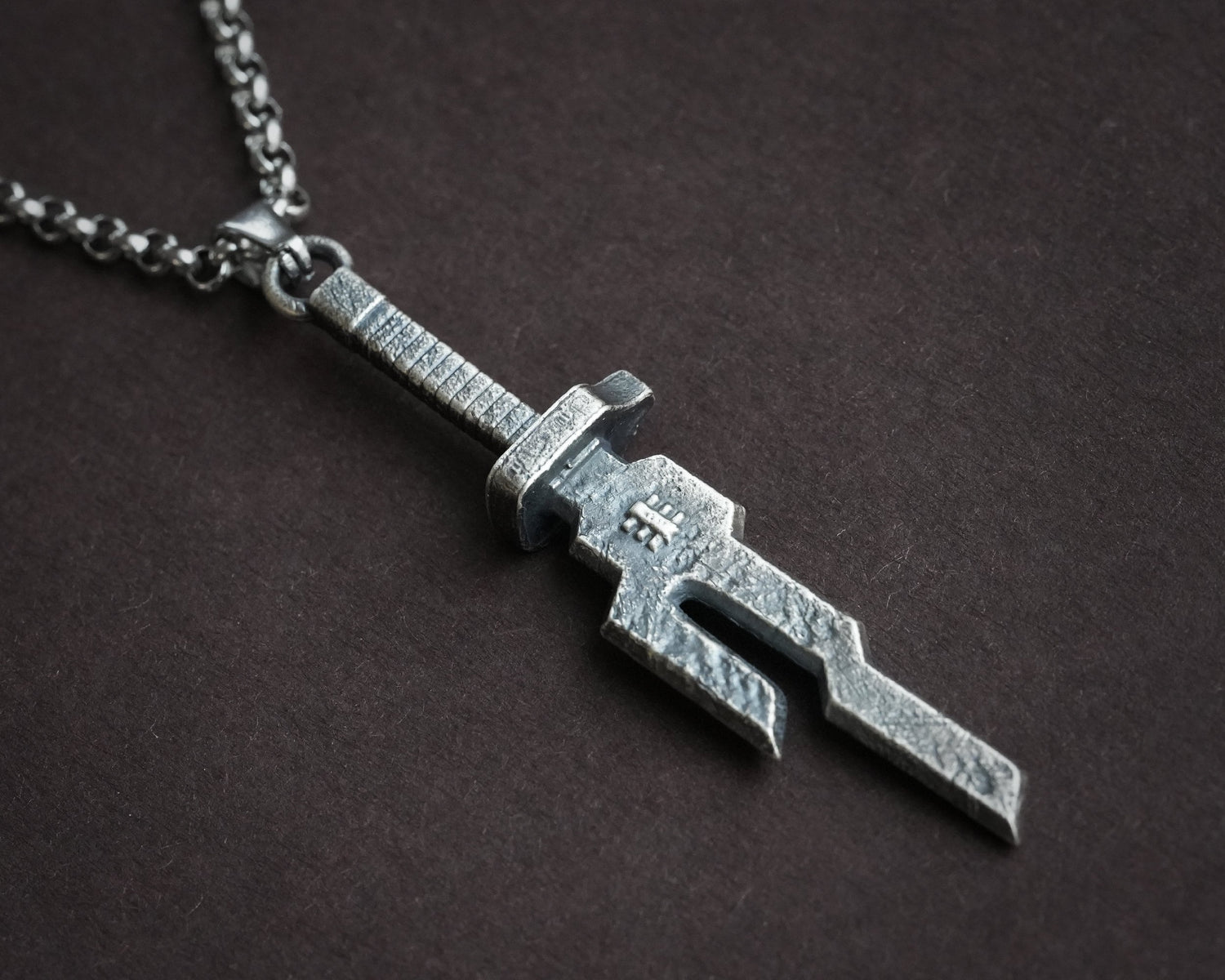 Silver necklace with Inverted Spear of Heaven pendant from Jujutsu Kaisen, featuring a detailed chain